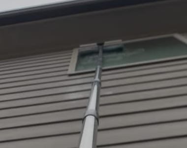 Pane Point technician detailing a window with an extension pole